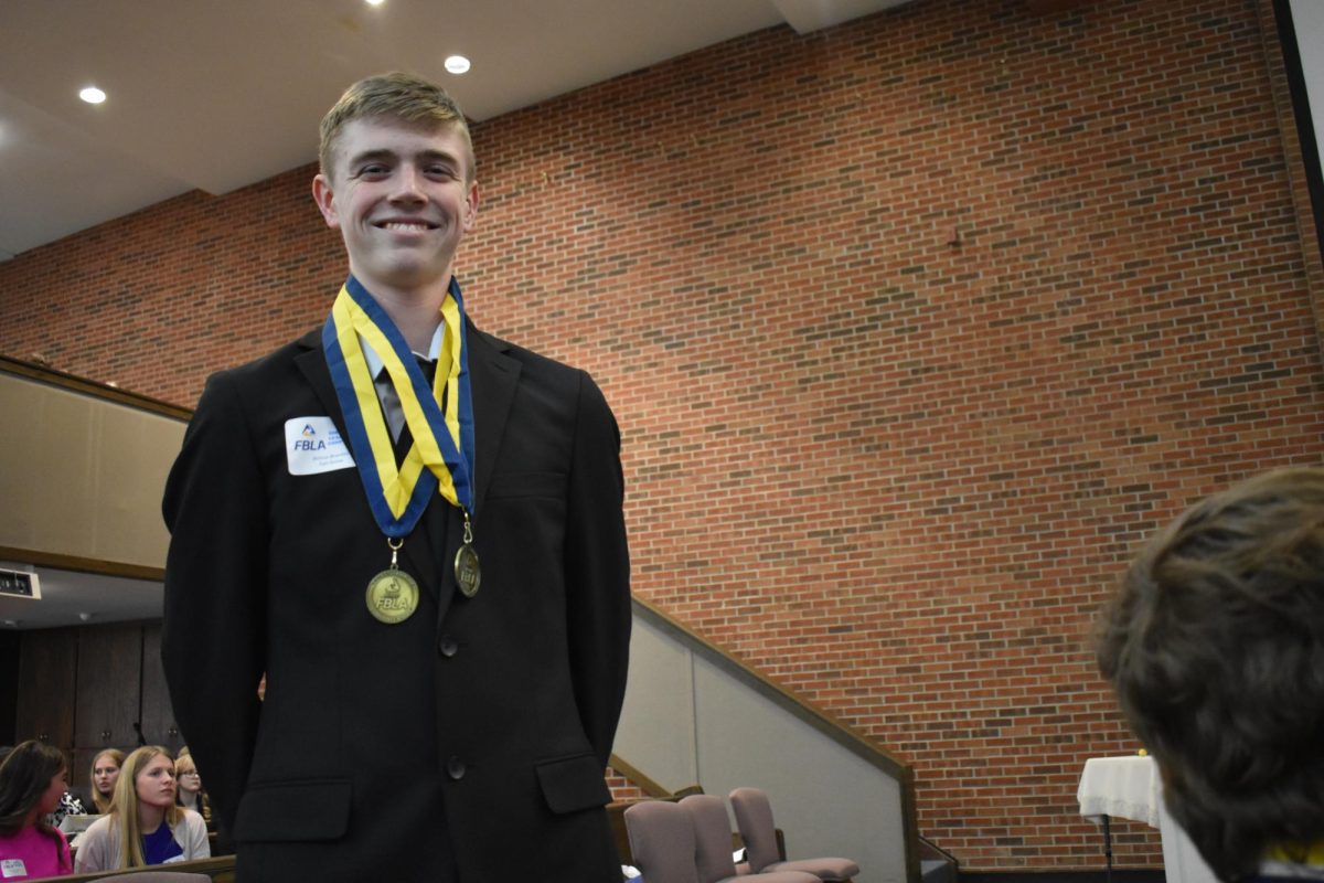Atticus Brandes (11) posing in the Bolivar Church at a FBLA Competition after receiving rewards.