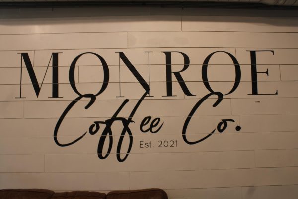 Monroe Coffee Shop logo on the wall inside the establishment