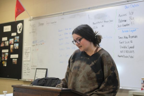 Erica Feith (11) reading one of her poems to the Poetry Club.