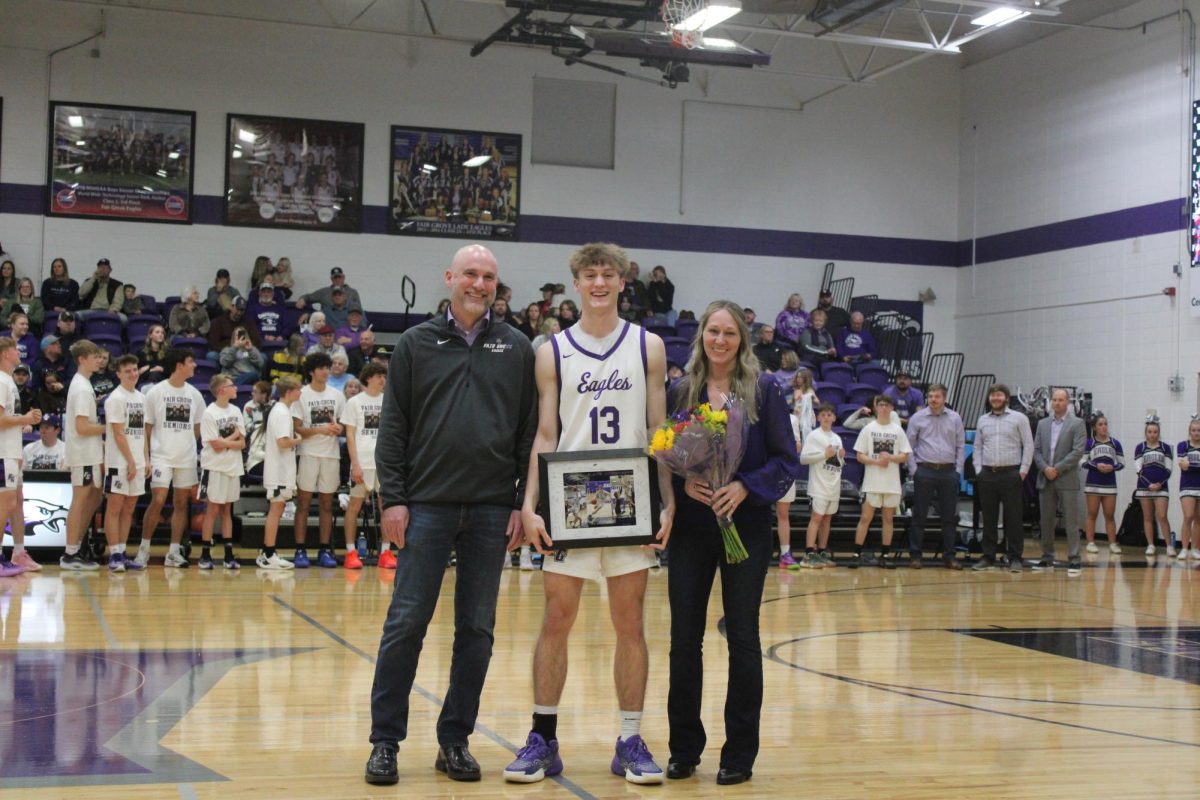 Basketball+senior+Blake+Winterberg+%28middle%29+being+escorted+by+his+parents%2C+Russell+%28right%29+and+Joanna+Winterberg+%28left%29+during+the+Boys+Basketball+and+Cheer+Senior+Night.
