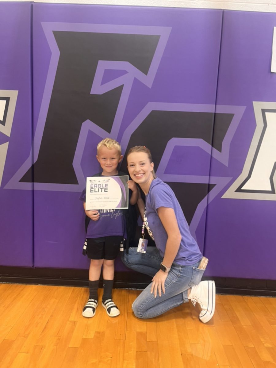 Jayden Miller posing with his teacher, Leah Masters after being awarded an Eagle Elite award (Photo provided by Krista Miller)