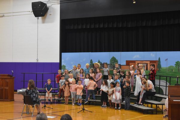 Kindergarteners at graduation performing for their families.