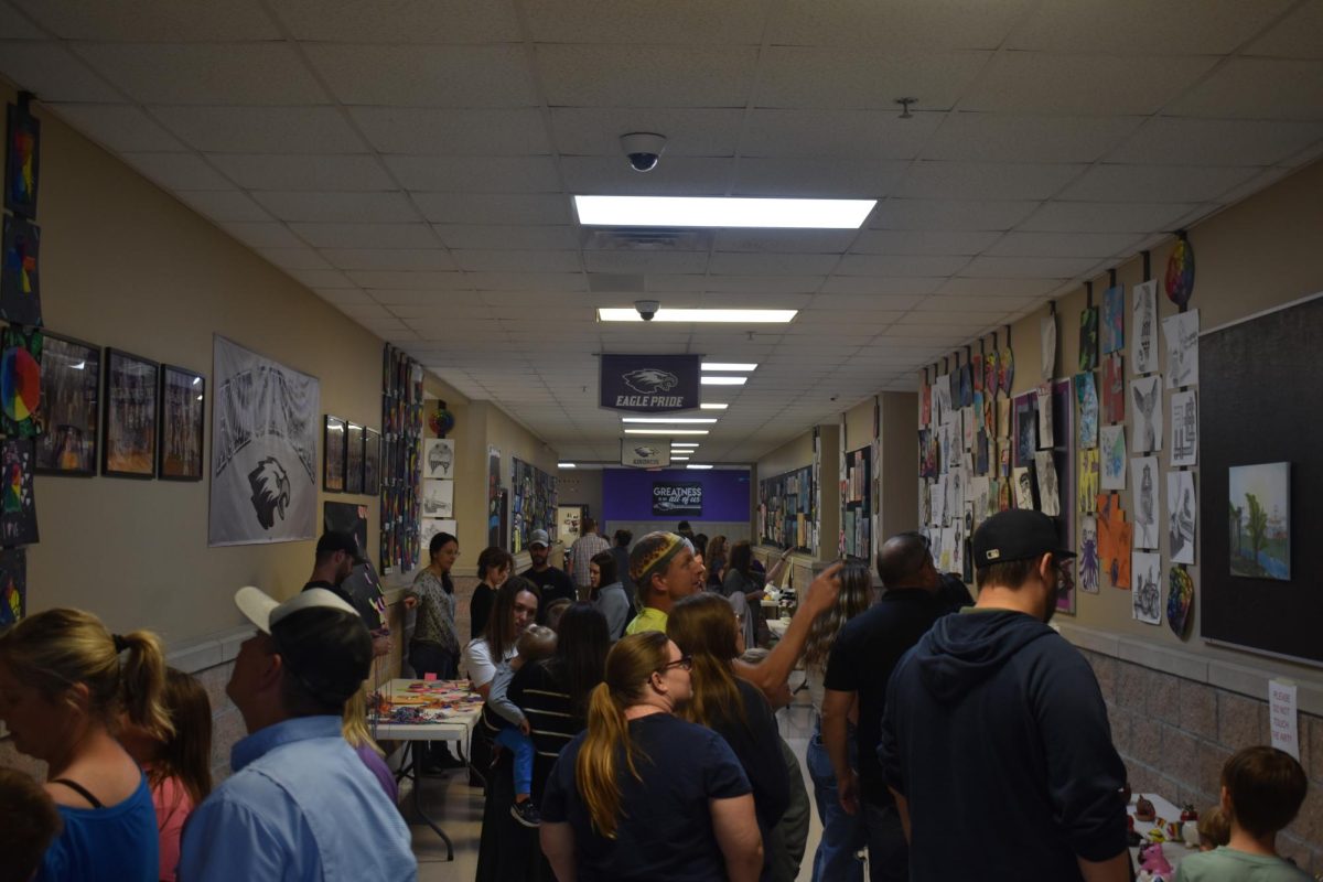 Fair Grove Middle School hallways filled with parents and students look at art work.