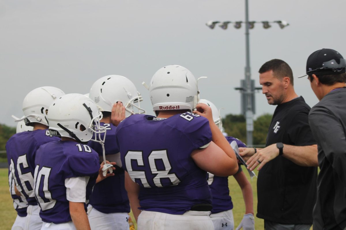 Middle School Football player Landon Estes (8) and other players on the sidelines in a game against Springfield Catholic on September 12th. 