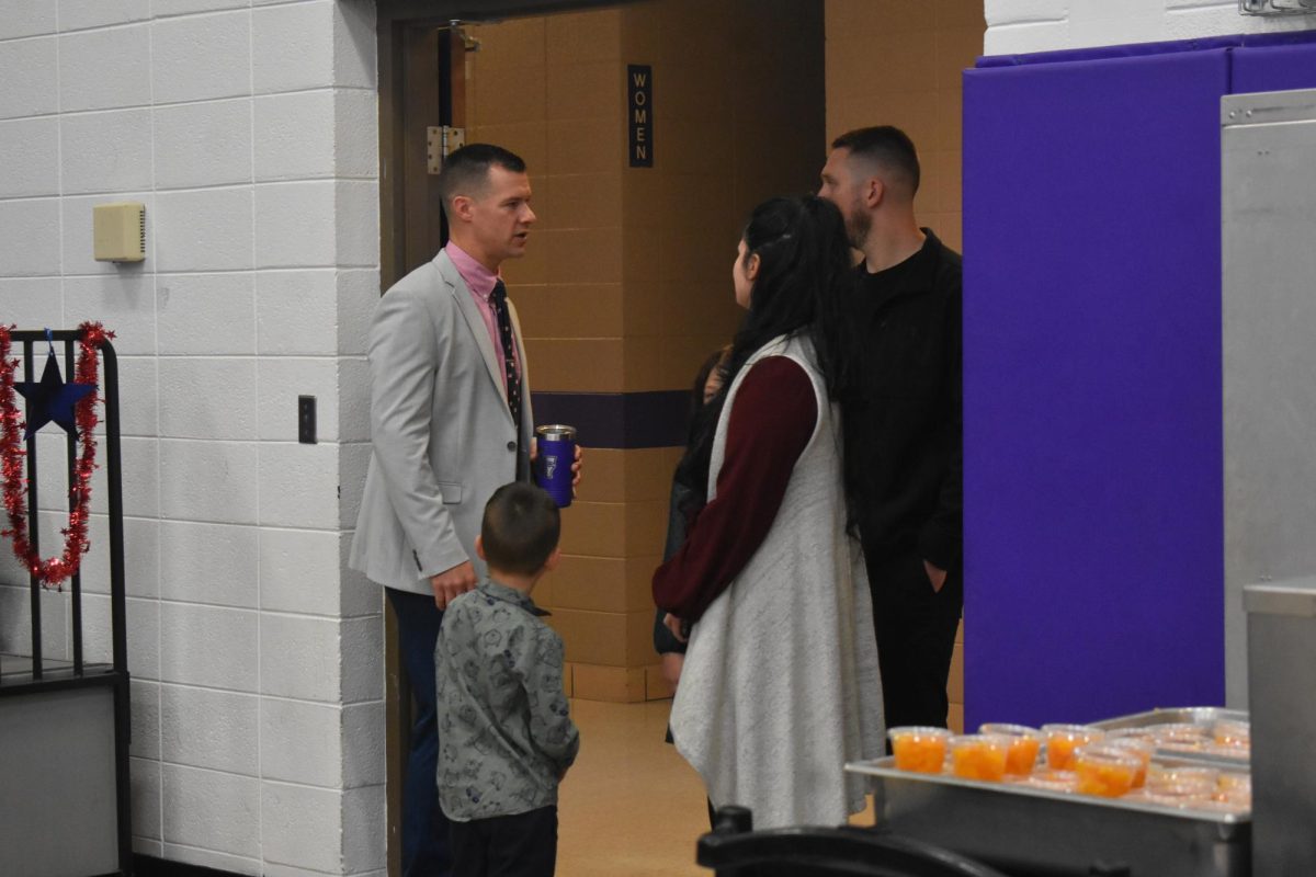 Fair Grove High School Principal, Christian Overstreet greeting Veterans and their families before they sit down to have breakfast at the Veterans Day Assembly. 