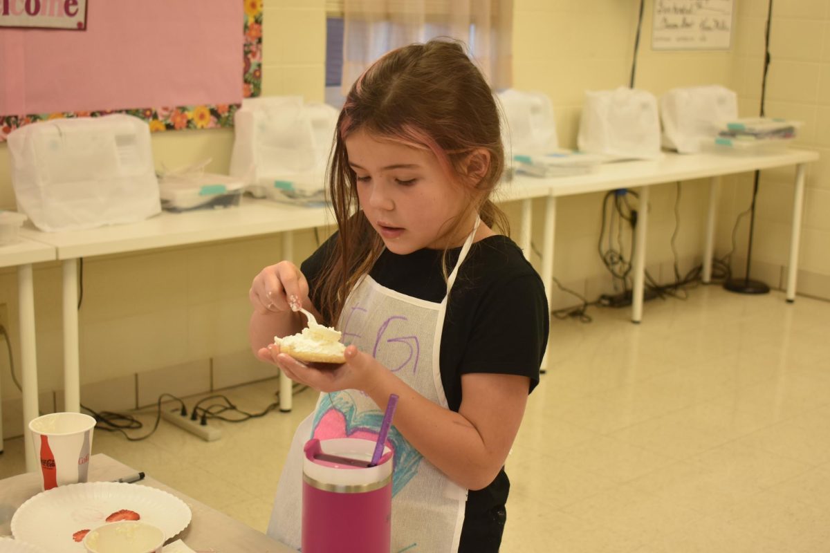 Breezy Dolan icing her dessert pizza at the Cooking With Kids event on 11/12. 