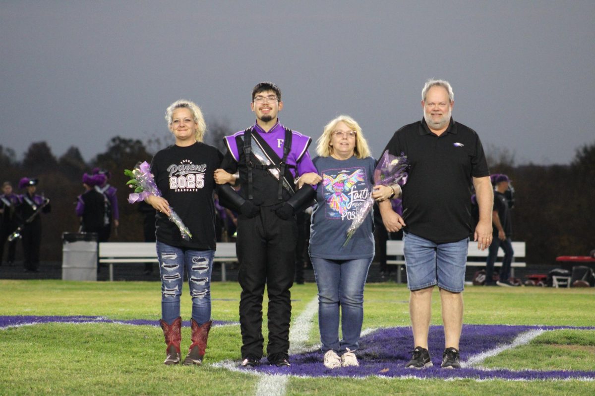 Keith Nolan (12) and his family walking with him on the Fair Grove Football Field for Senior Night. 
(Left to right: Charlene Nolan, Keith Nolan (12), Edna Koerble, and Brian Keorble)