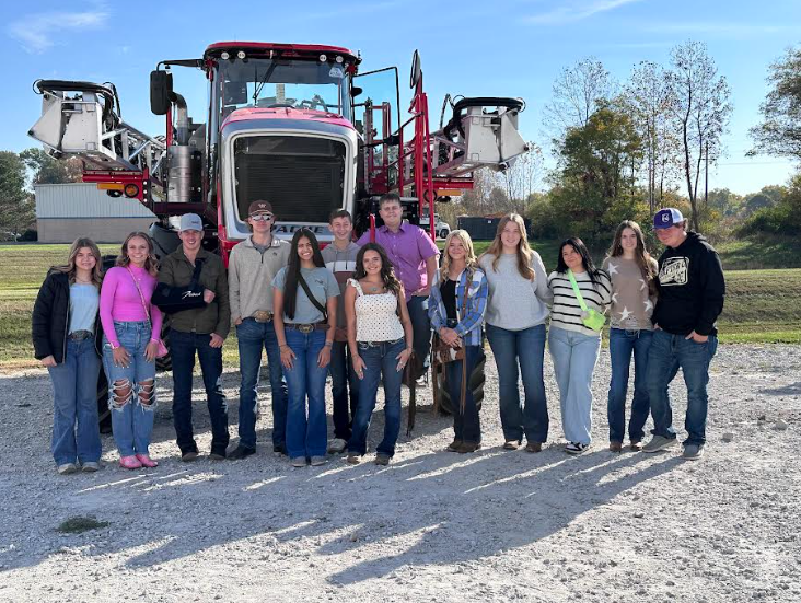 FFA (Future Farmers of America) members, that attended the National FFA convention, standing in front a sprayer at an ET Sprayer tour. 