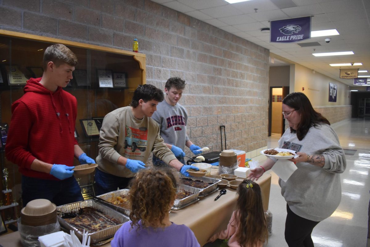 Students Kellan Kirkpatrick(12), Dylan George (11), and Carson Trussell (11) serving food at Coopers Christmas Celebration.  