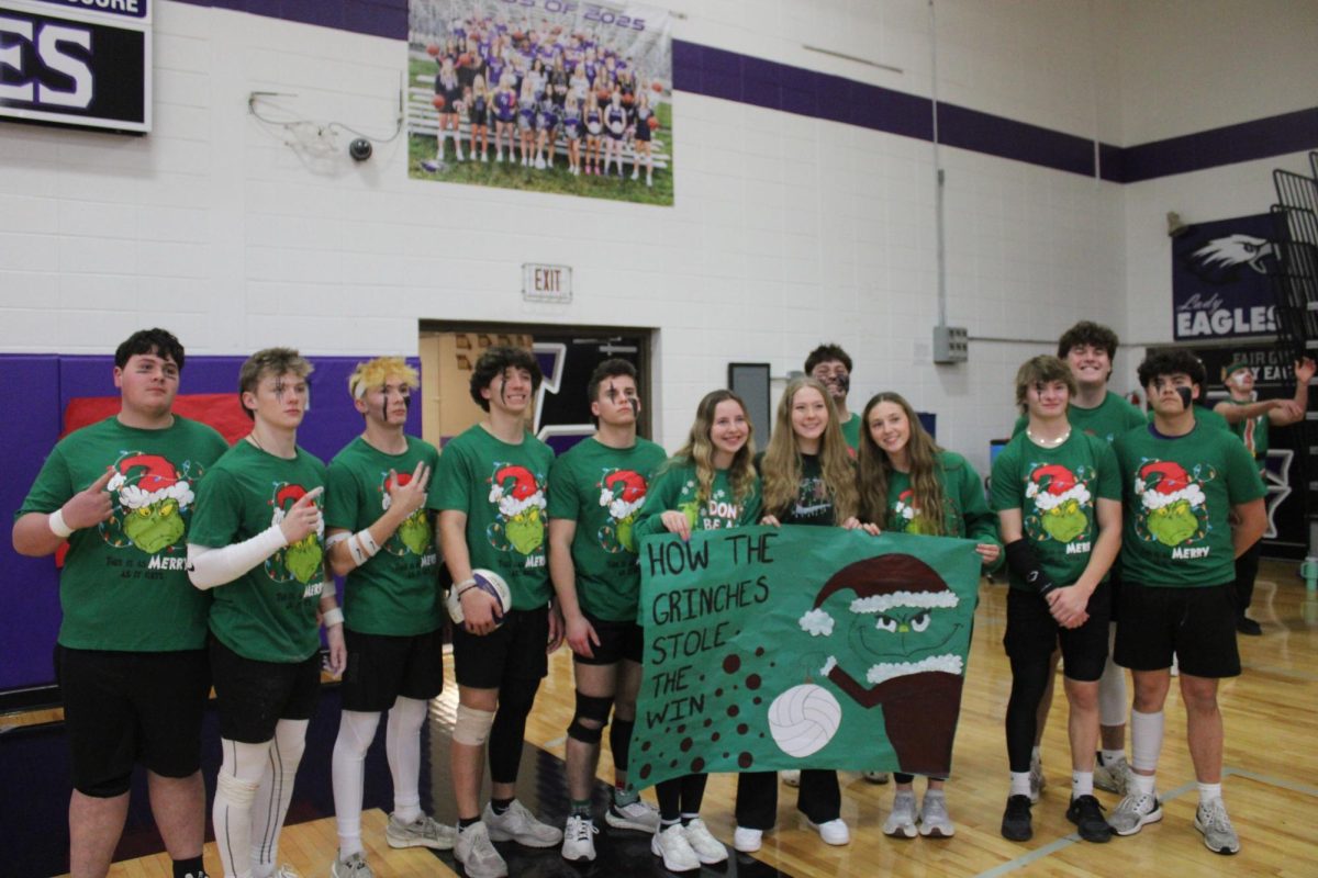 ManPuff team "The Grinches" posing with their banner before the tournament begins. From left to right: Payton Gann (11), Carson Trussell (11), Macklen Johnson (11), Adrick Wilson (11), Dylan George (11), Kenna Fishback (11), Quincy Williams (11), Gage Green (11), Leila Huff (11), Jakoeby McDannald (11), Luke Trehal (11), and Jackson Austin (11).