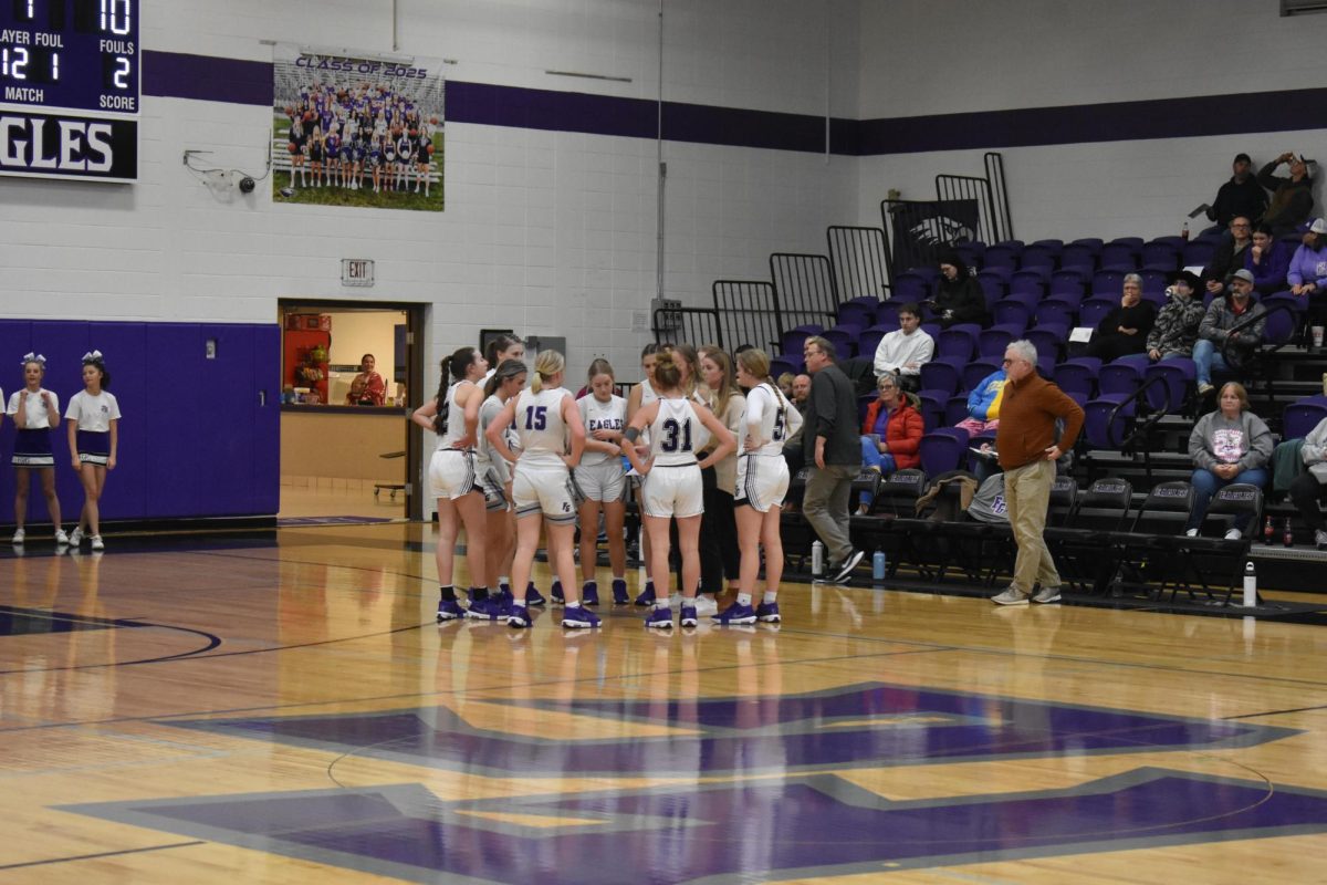 Fair Grove Girls JV basketball huddled together before a game against Rock Bridge on 12/20 at home. 