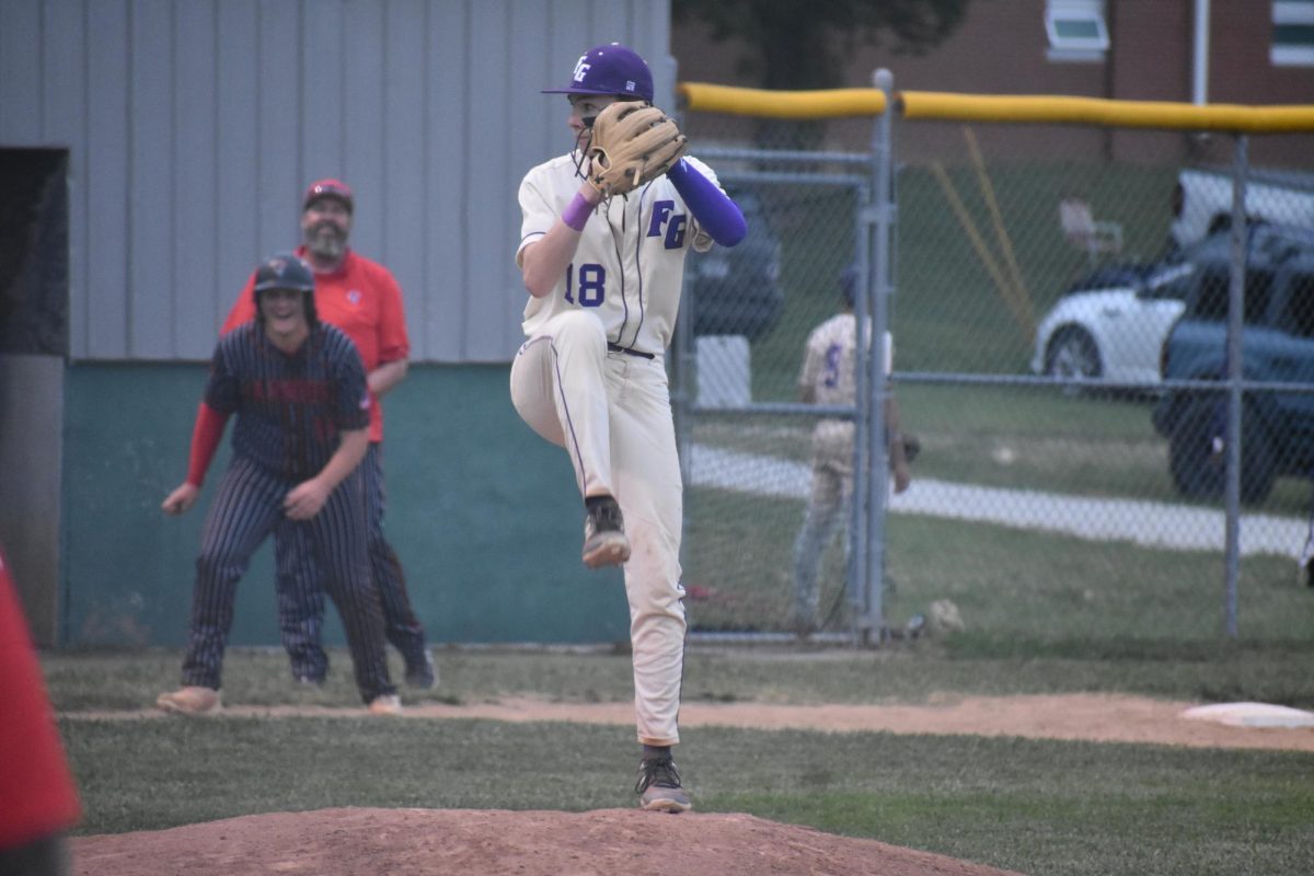 Pitcher Macklen Johnson (11) goes into the windup in a game against New Covenant last Spring on April 18, 2024. The Eagles won the game 8-2. 