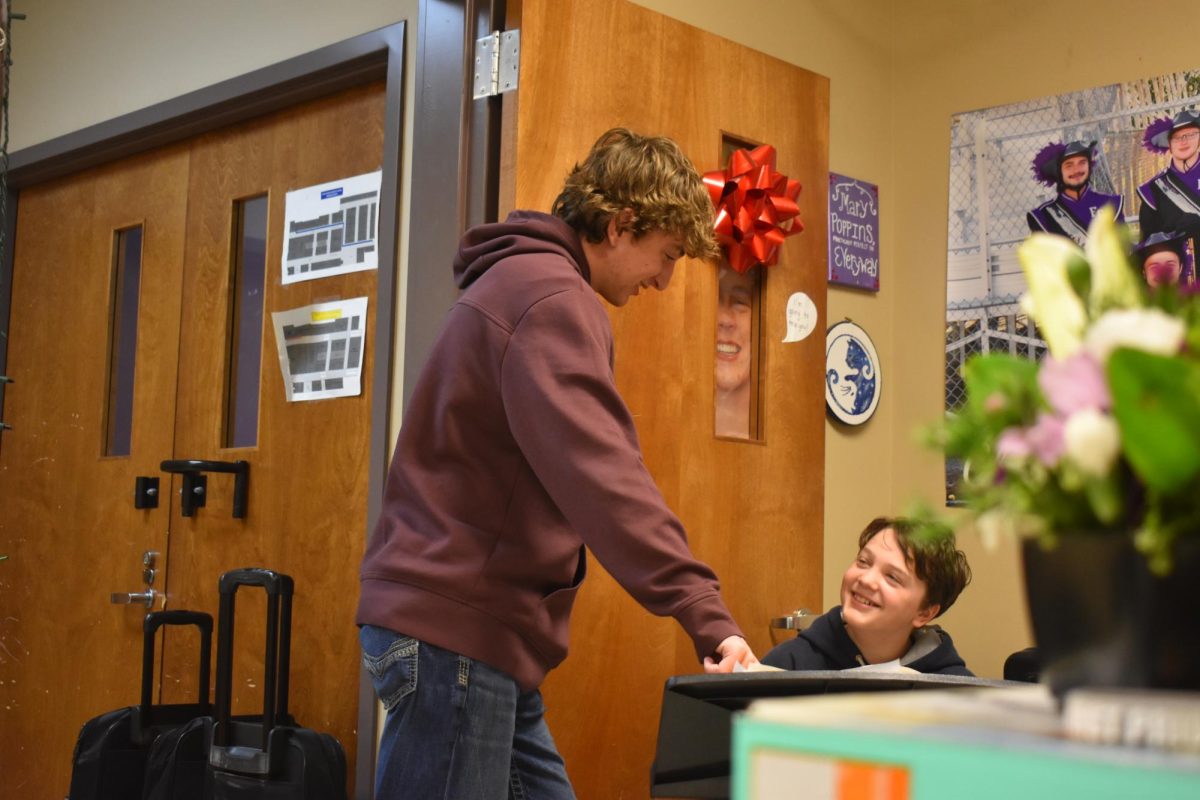 Senior Jayden Rice in his A+ class, helping 7th grader Dexter Bennett.