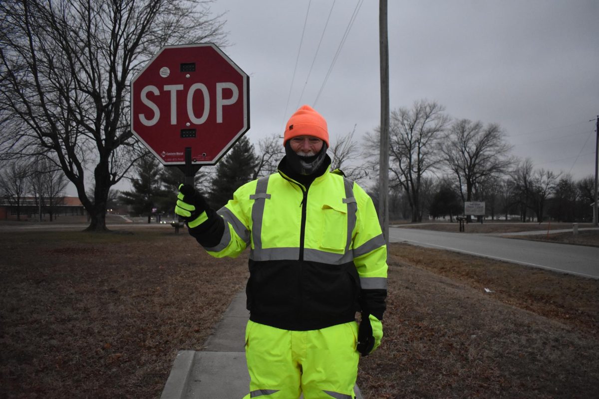 Mr. Mike Downing outside the Fair Grove High School waiting for students to arrive for him to help them cross the busy road safely. 