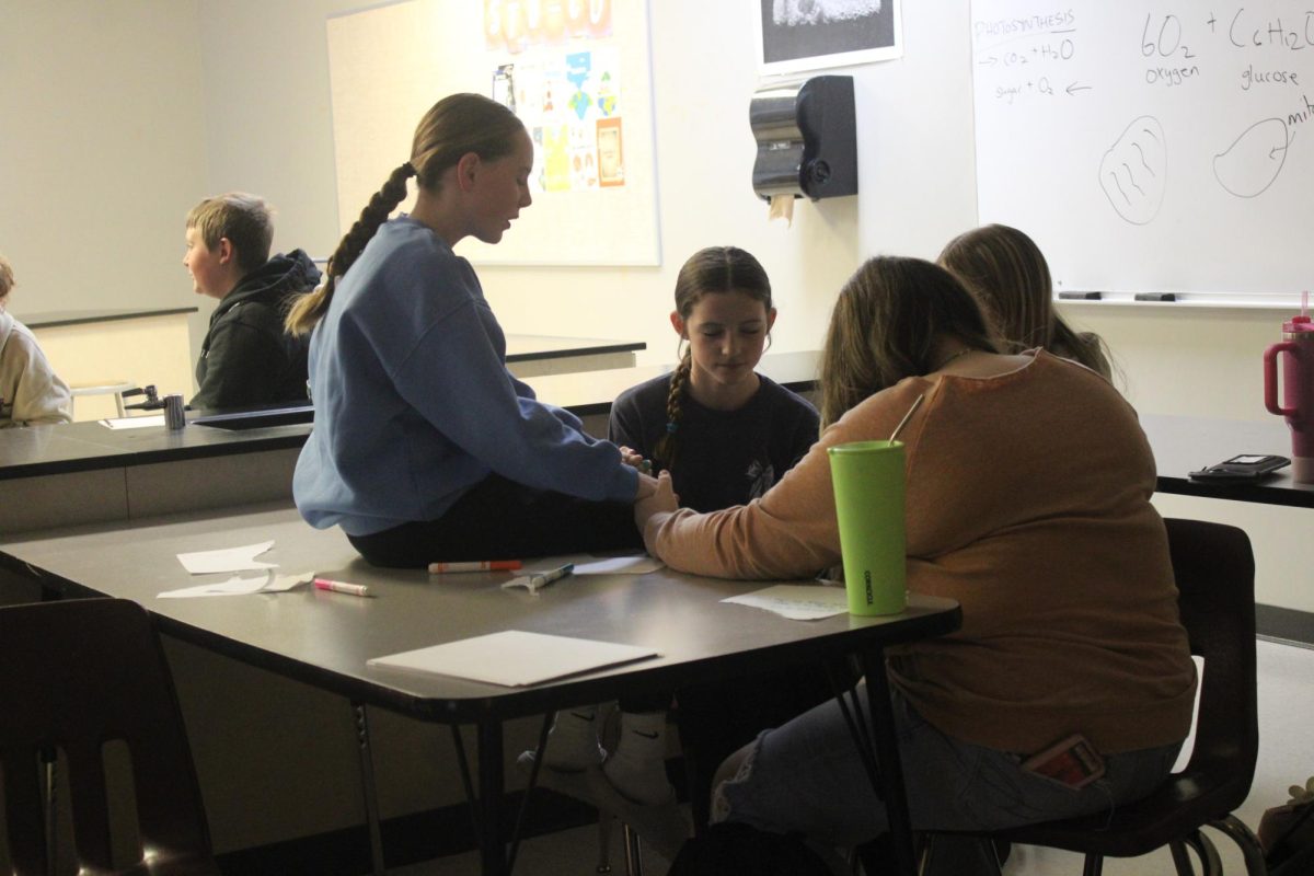 Payton Martin (7), Reygan Hallam (7), and other students joining hands in prayer. Photo taken during FCA meeting on Thursday, January 23rd.