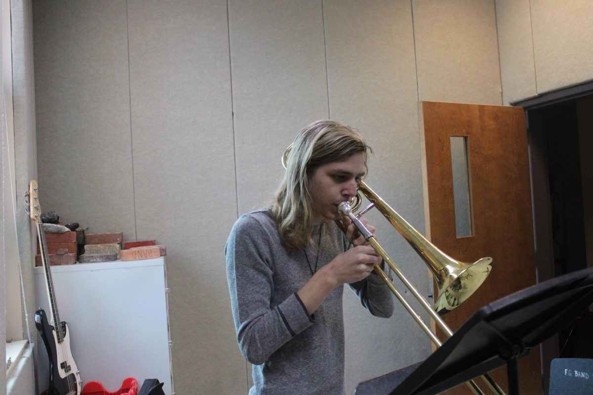 Lee Van Cleave preparing for district band, by practicing his instrument. 