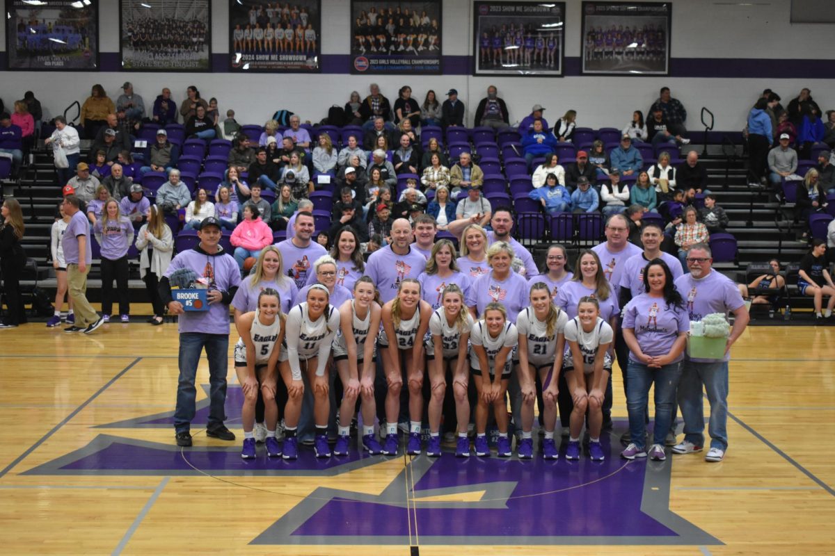 Parents of the Fair Grove Lady Eagles Basketball Team posing for the Senior Night Photo. From left to right: Troy Daniels, Marc Green, Carrie Green, Mike Bell, Talon Skouby, Chrsity Skouby, Jason Hart, Angie Skouby, Christa Padgett, Kelly Stallings, Tyler Padgett, Chris Stallings, Melissa Carter, Sam Carter, Brooke Daniels, Cam Hart, Abbey Green, Shea Skouby, Ashton Bell, Meadow Carter, Emma Padgett, Emaley Stallings 