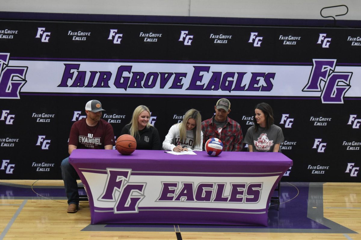 Brooke Daniels signing documents to be a part of Evangel University's Basketball and Volleyball teams with her family on April 16, 2025. From left to right: Tyler Perryman, Rhonda Perryman, Troy Daniels, and Molly Daniels. 