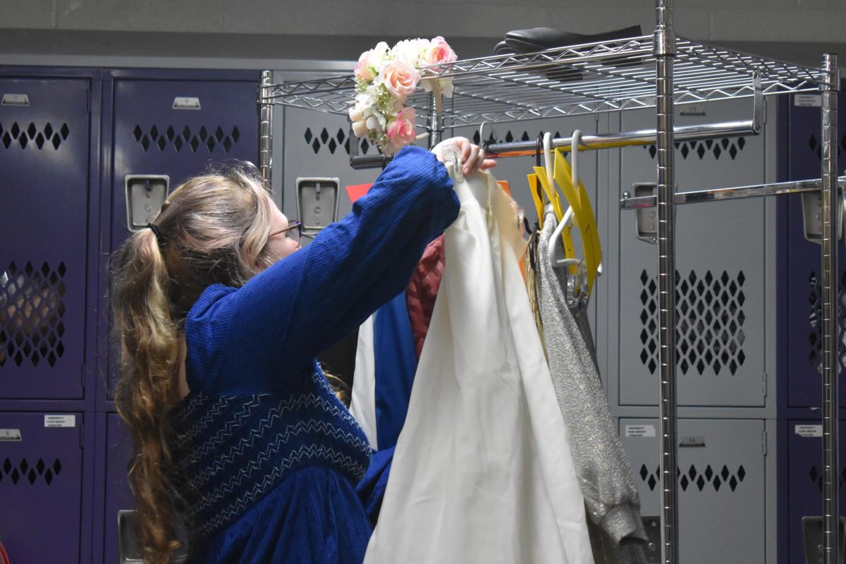 Mackenzie Jenkins (11) organizing the costume rack in stagecraft class, to prepare for the play Fair Grove Theater had on 4/18.