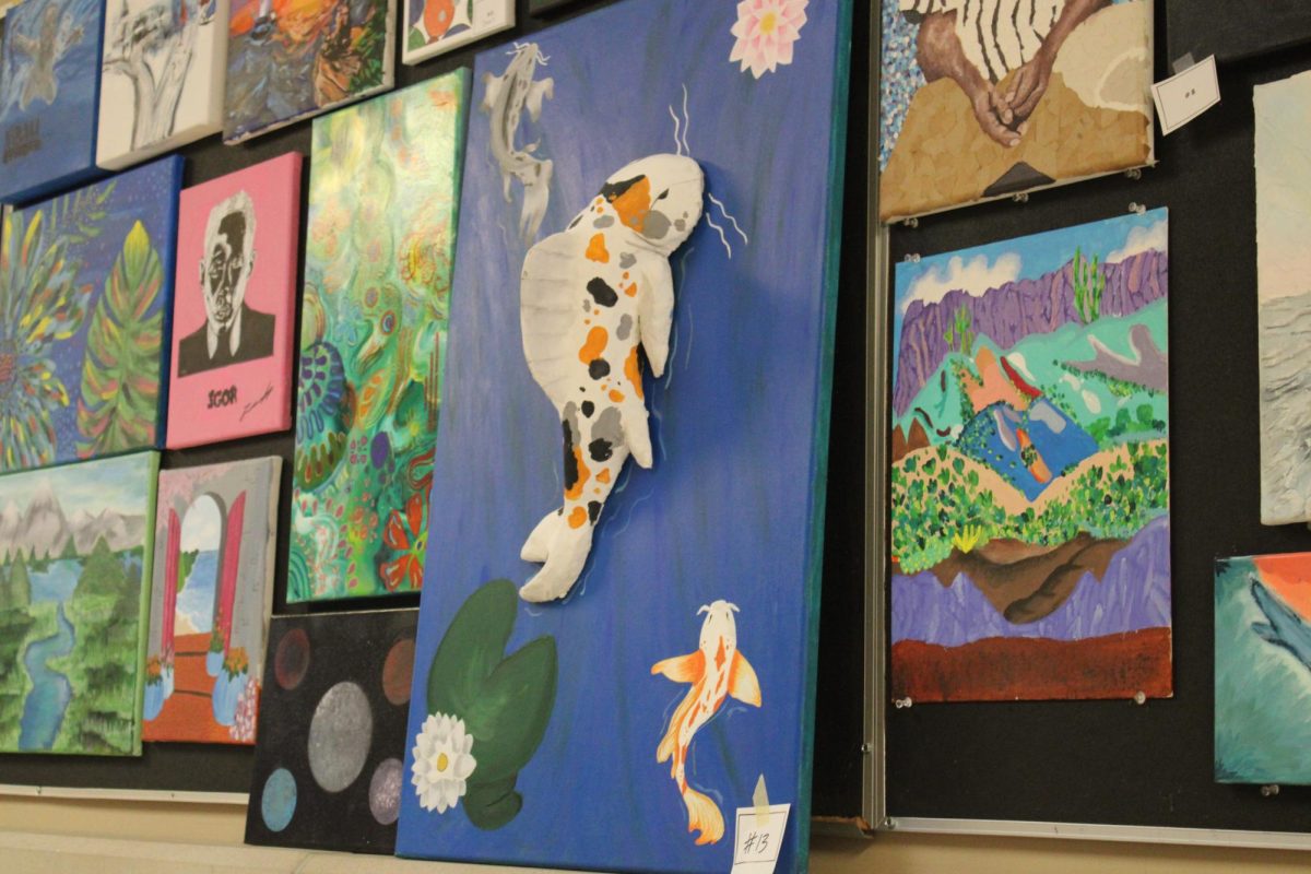 Art canvases and paintings are hung up on hallways walls, displaying beautiful pieces and creativity in the middle school/high school hallways