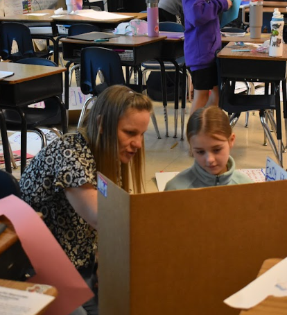 Shiawa Page helping her student, Jera Lambert, prepare her project for Impactful Missourians Day. 