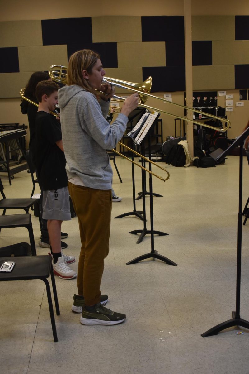 During jazz band practice, Lee Vancleave(11) is practicing his music and playing his trombone. 