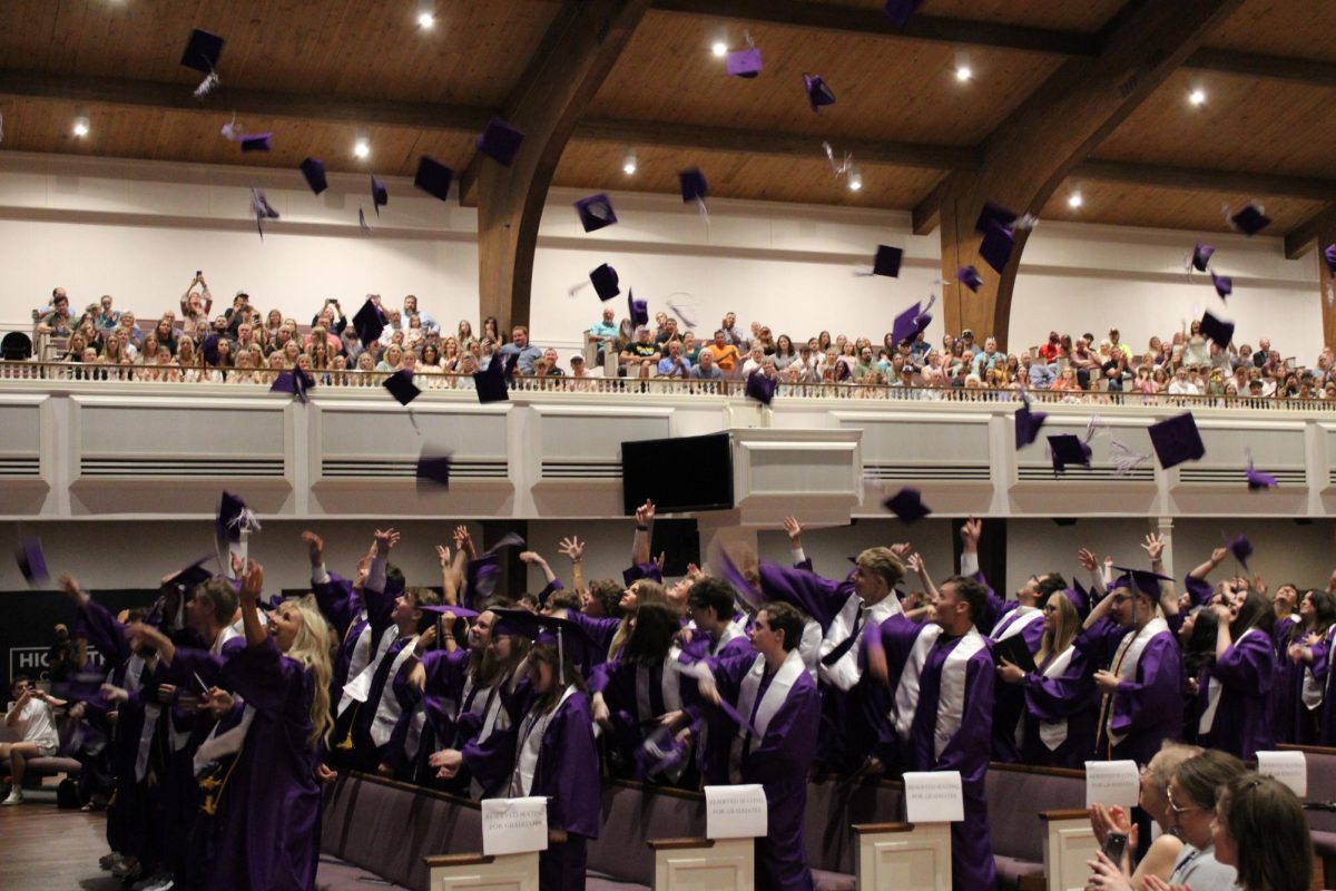 Fair Grove 2025 graduates throwing their caps in the air as they celebrate their last moments of high school.