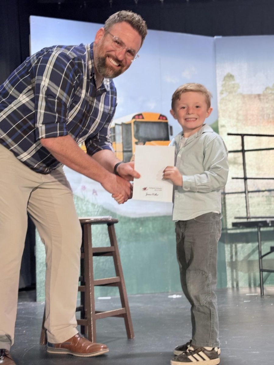 Ryan Buffington congratulating James Miller for graduating Kindergarten.