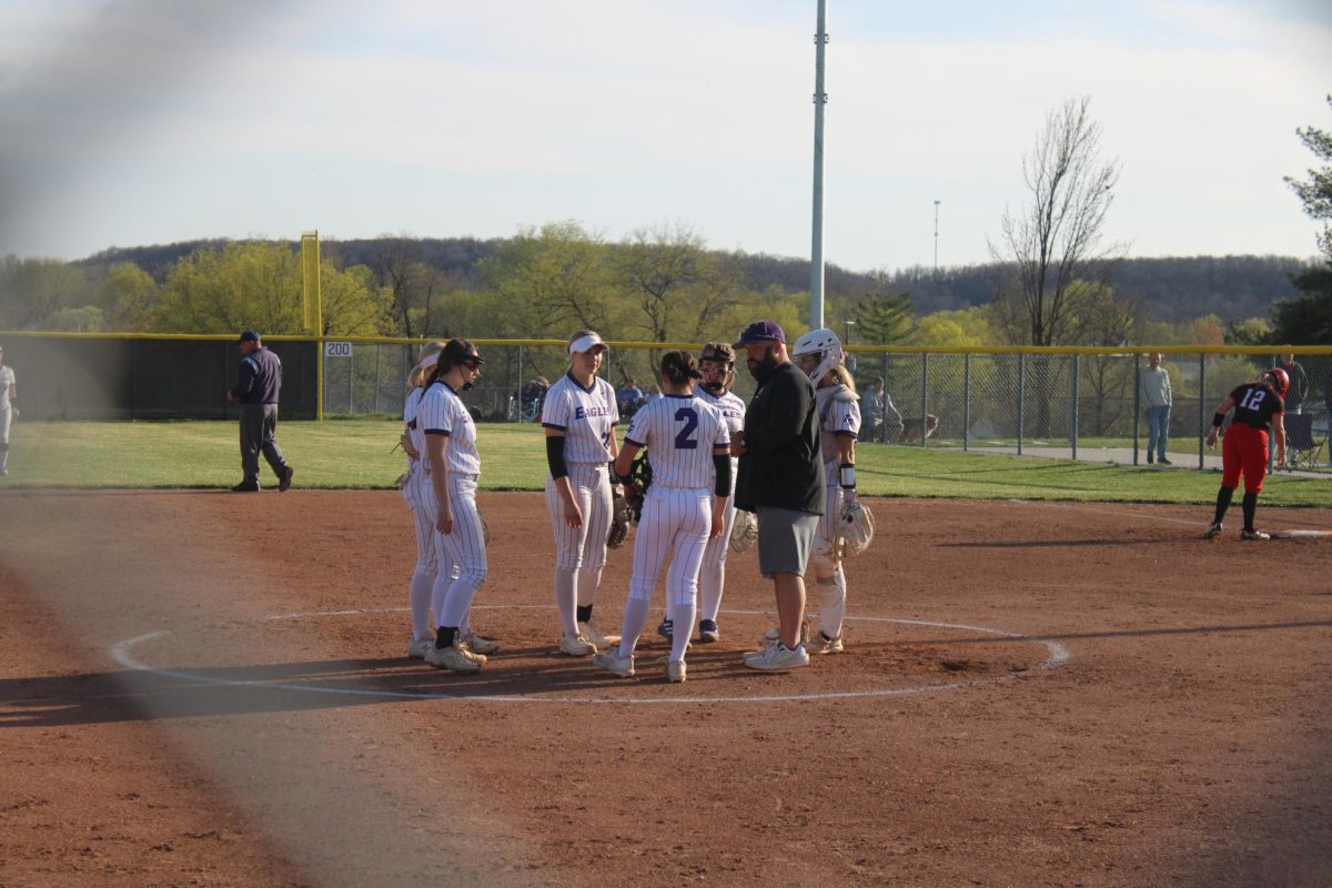 The Fair Grove Softball team huddling in the pitching circle during their home game against Eldorado Springs at home on 3/31. 