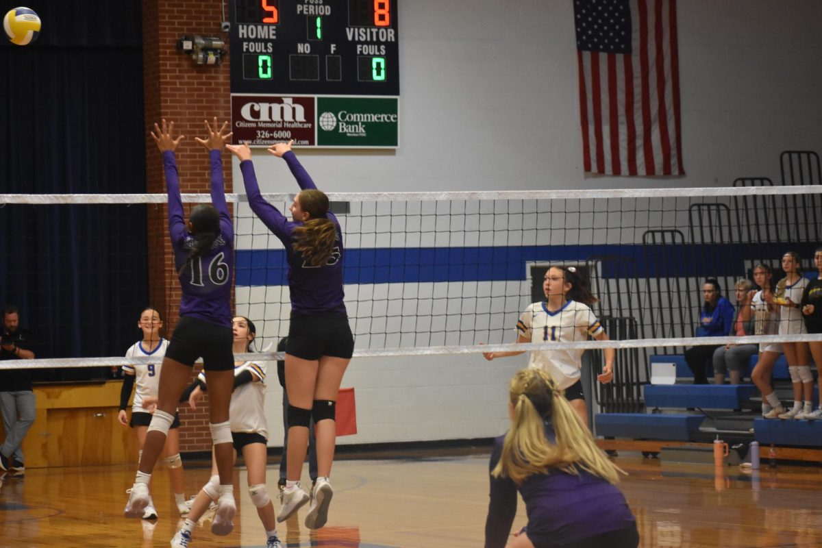 Eighth graders Halei Davidson and Dia Draper going up to the net to block a kill from the other team as defence gets ready to receive the ball. Photo taken on September 11th at Bolivar