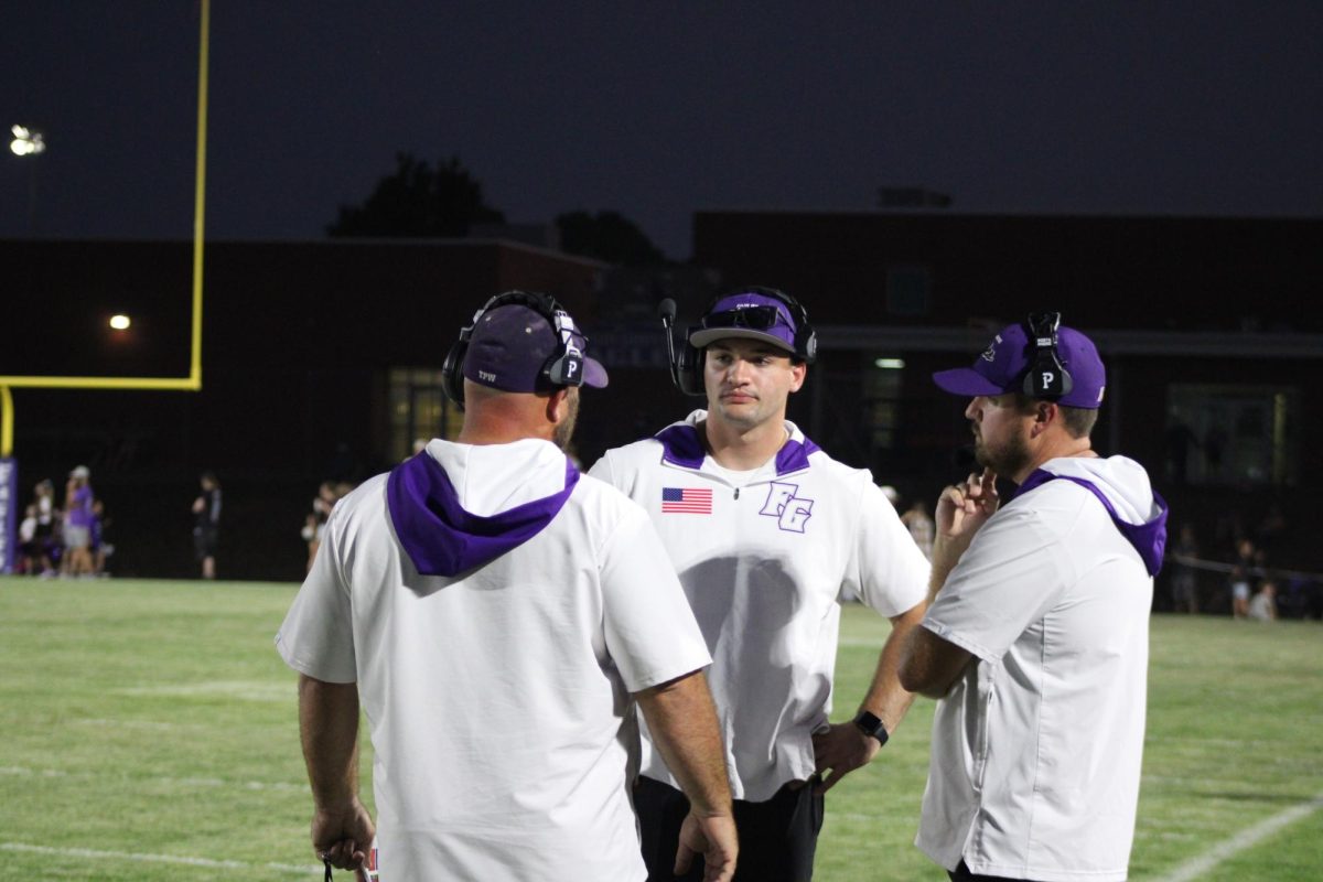 Jake Henson (middle) meeting with the head football coach Bill Voorhis (left) and assistant football coach Chris Holt (right) during the first home football game. Fair Grove beat Buffalo with a final score 28-14.