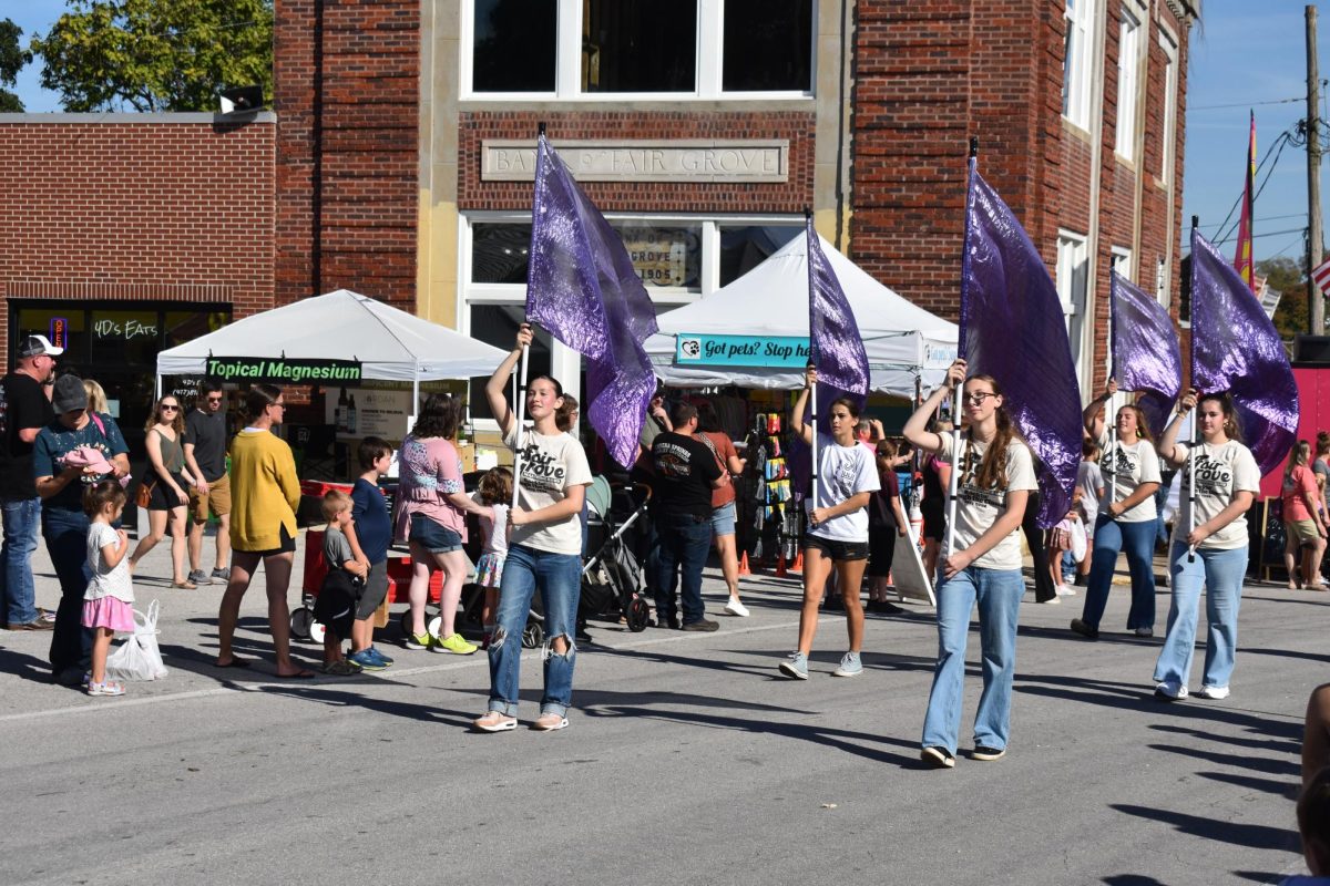Fair Grove High School Color Guard captains Lacie Workman(10) and Madison Crews(11) leading the band as they march up the Old Mill Road during a parade at the Fall Festival on September 27th.