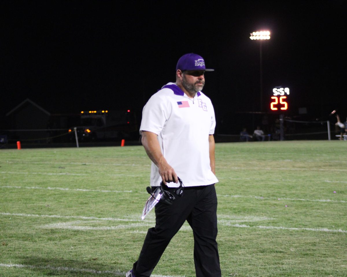 Coach Hayman walking across the field after a team huddle. This was the Fair Grove football game against the Buffalo Bison on September 9th 2025.