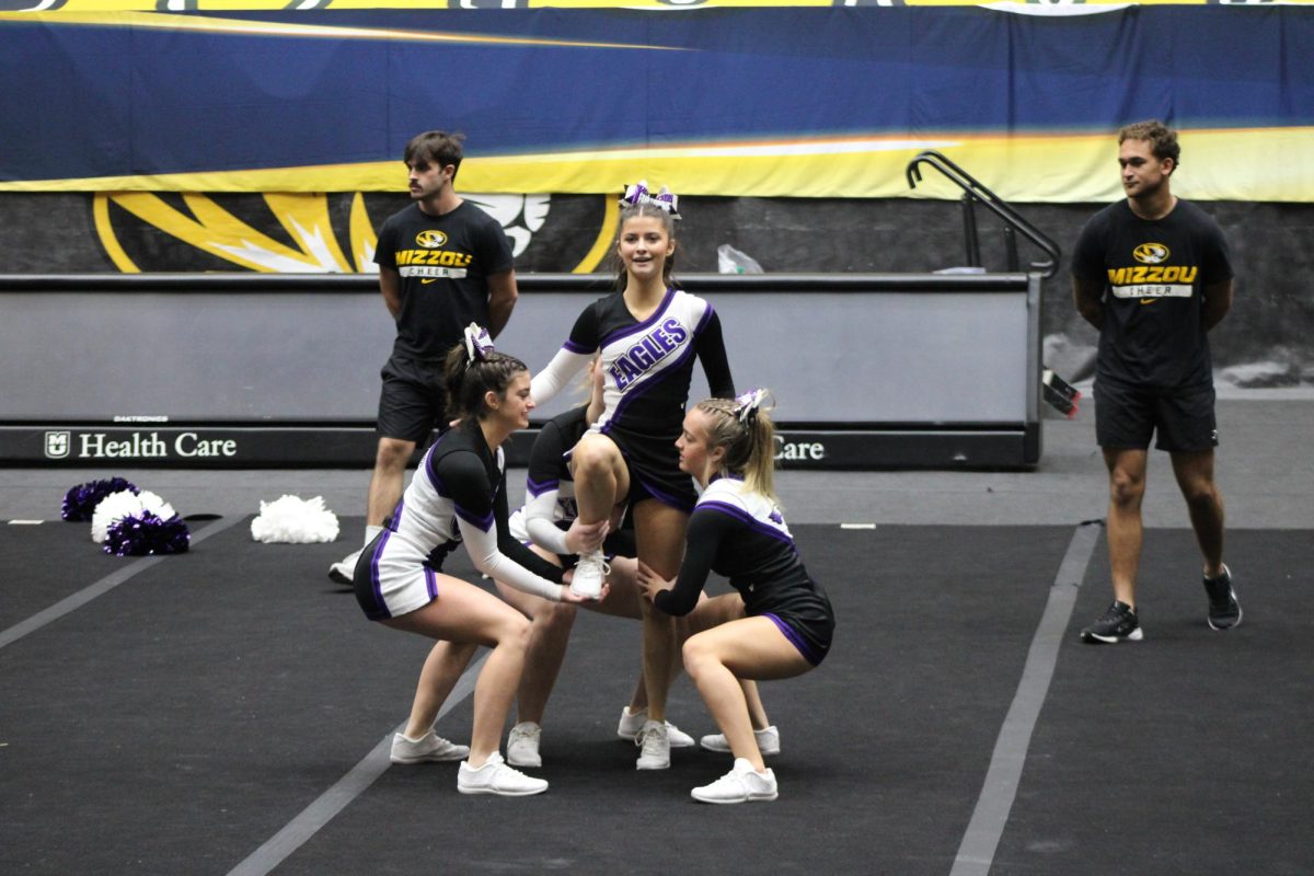 Cheerleaders from left to right: Olivia Broyles (9), Avary Austin (11), and Elizabeth Taylor (12) preparing a cheer up for the state competition. The Fair Grove Cheer team placed 6th overall at state. 