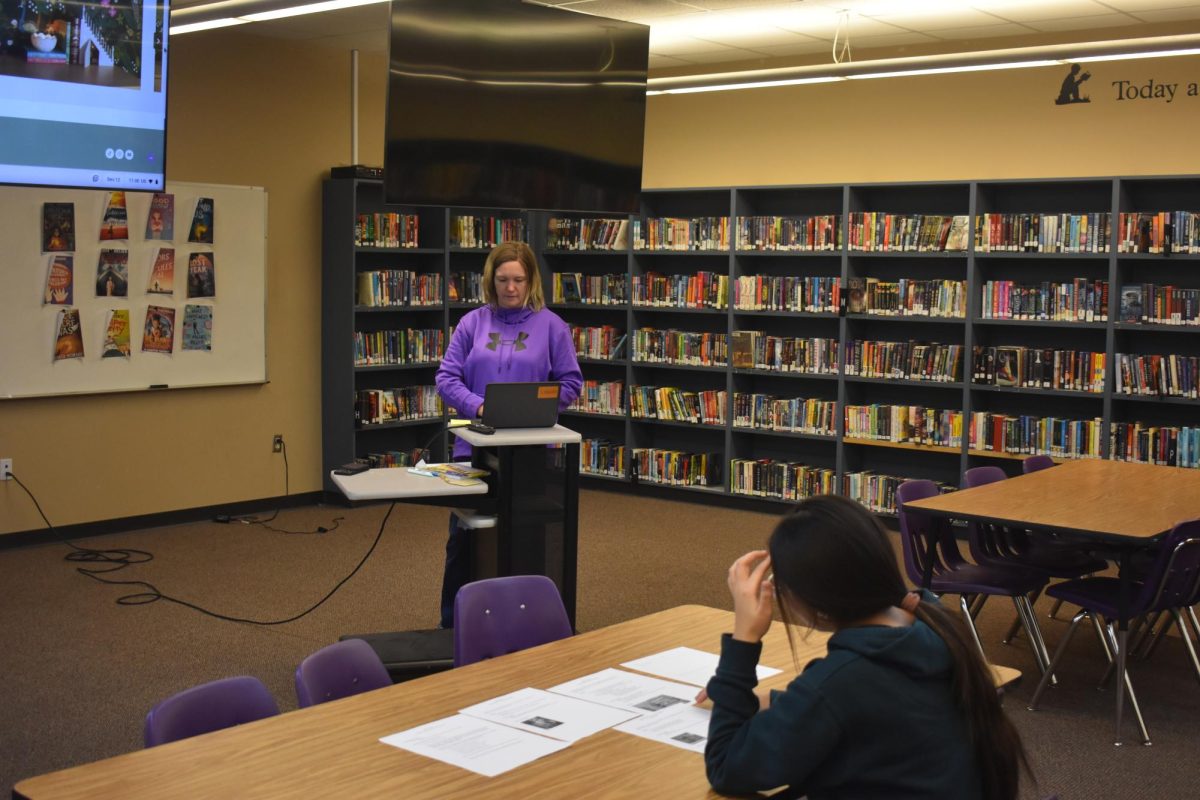 Epsilon Beta is a book club that holds competitions for its members. In this photo Lacey White is giving a presentation on what the next competition will be to member Christa Chumbley (11). 