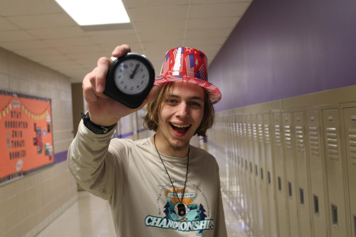 Lee Van Cleave (12) holding a clock when its striking twelve, ringing in the new year with party hats and laughter.