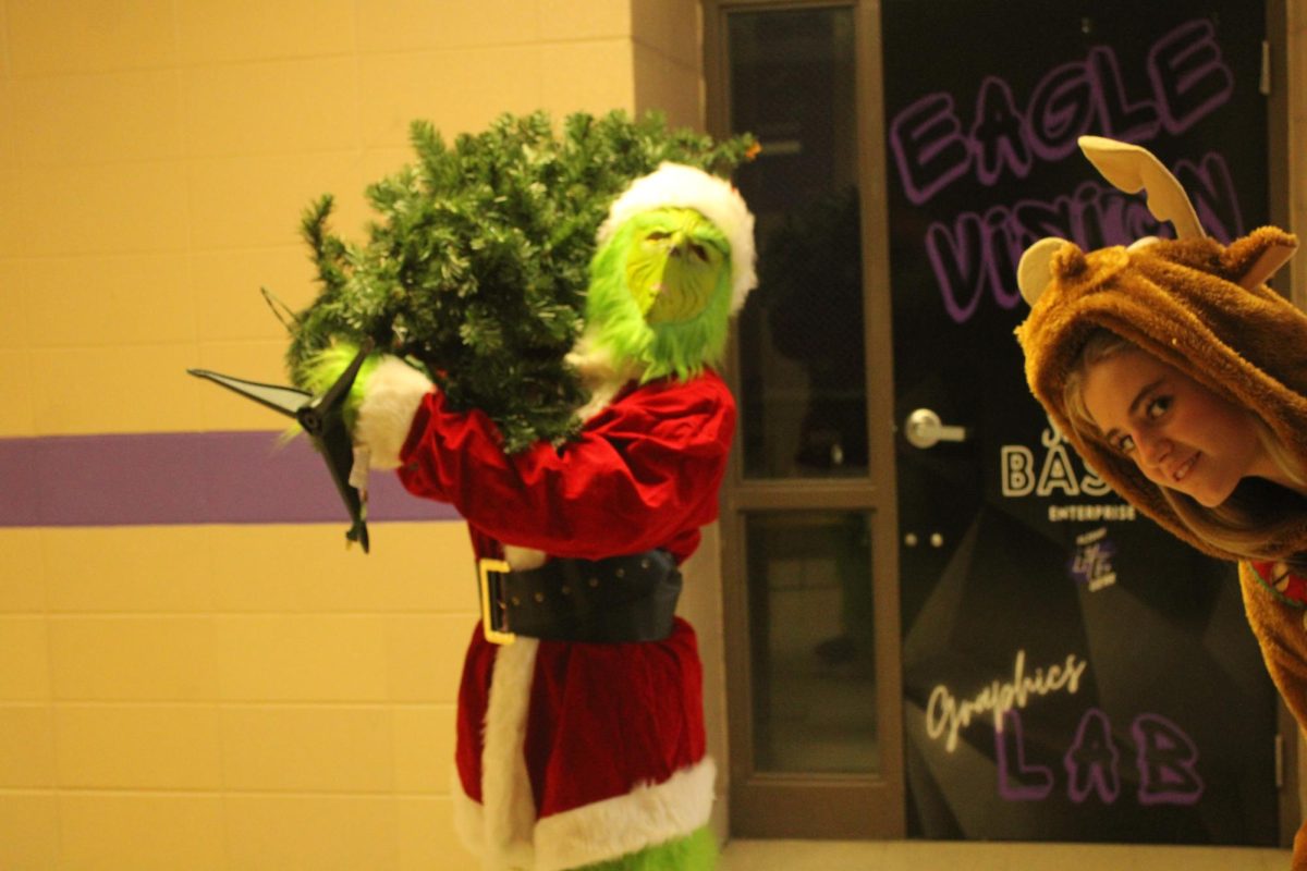 Isabel Bruner (10) in the Grinch suit, and Lillie Arnold (10) in the Max costume were caught stealing Mrs. Dunning's Christmas tree! Lillie and Isabel ran around bringing festive spirits to students.