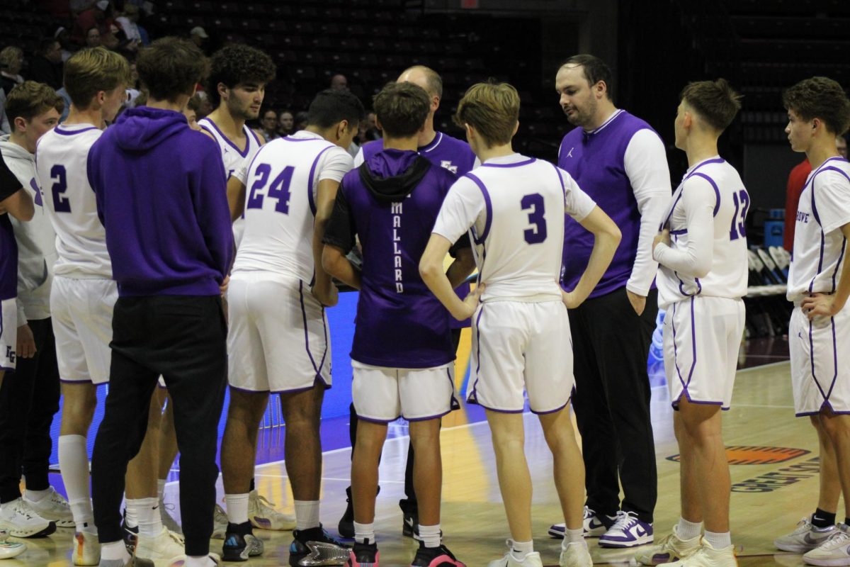The Fair Grove Boy's Basketball team in a huddle discussing their next moves and plays against Nixa in the Blue and Gold tournament. 
In the 
From left to right: Grant Fuller, Finn Harp, Kolton Klindworth, Logan Wilson, Dude Mallard, Gavin Strong, Coach Henson Blake Baxter, Jacob Shurtz
