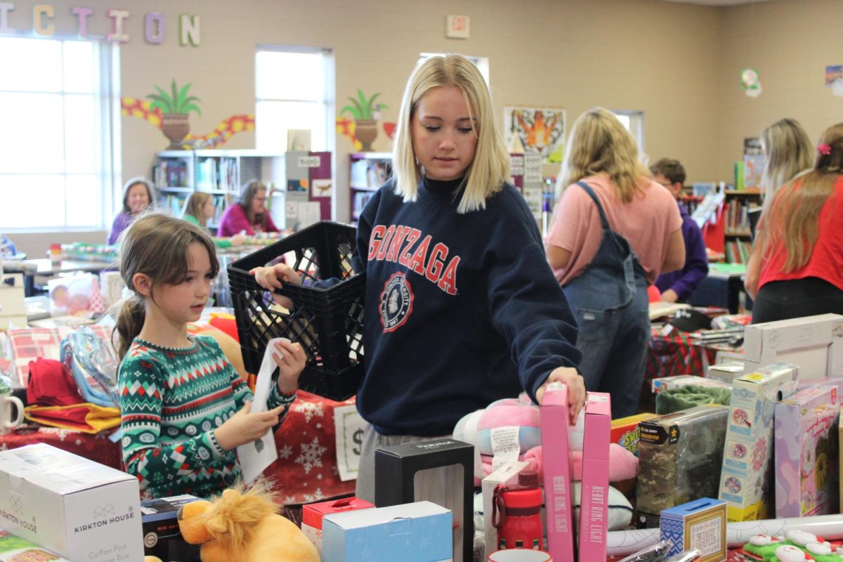 Holiday shops let the students choose from a wide variety of items. Peyton Hoskins (2) and Mckenna Zanzie (10) searching for the perfect gift.