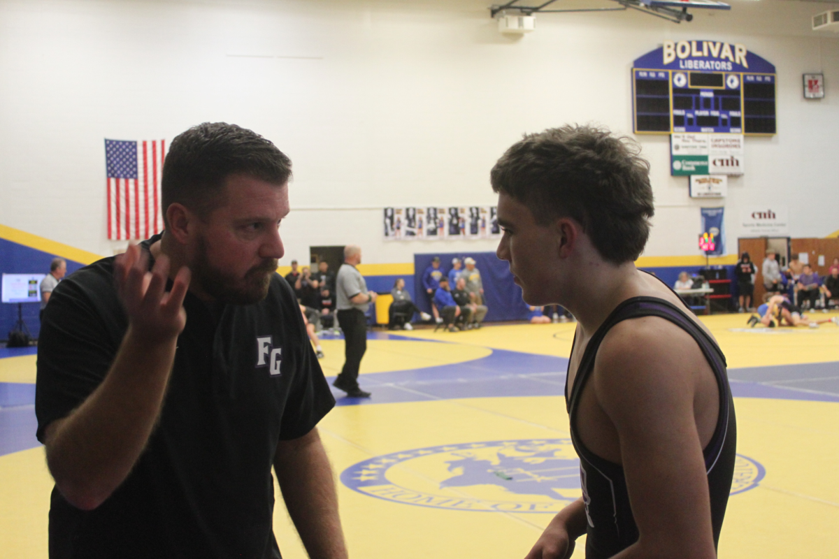 Head coach Chris Holt coaching 2025 graduate Alex Mahan at the Bolivar wrestling meet held on December 7, 2024. This meet held nine teams. Mahan placed seventh in the 150 weight class.