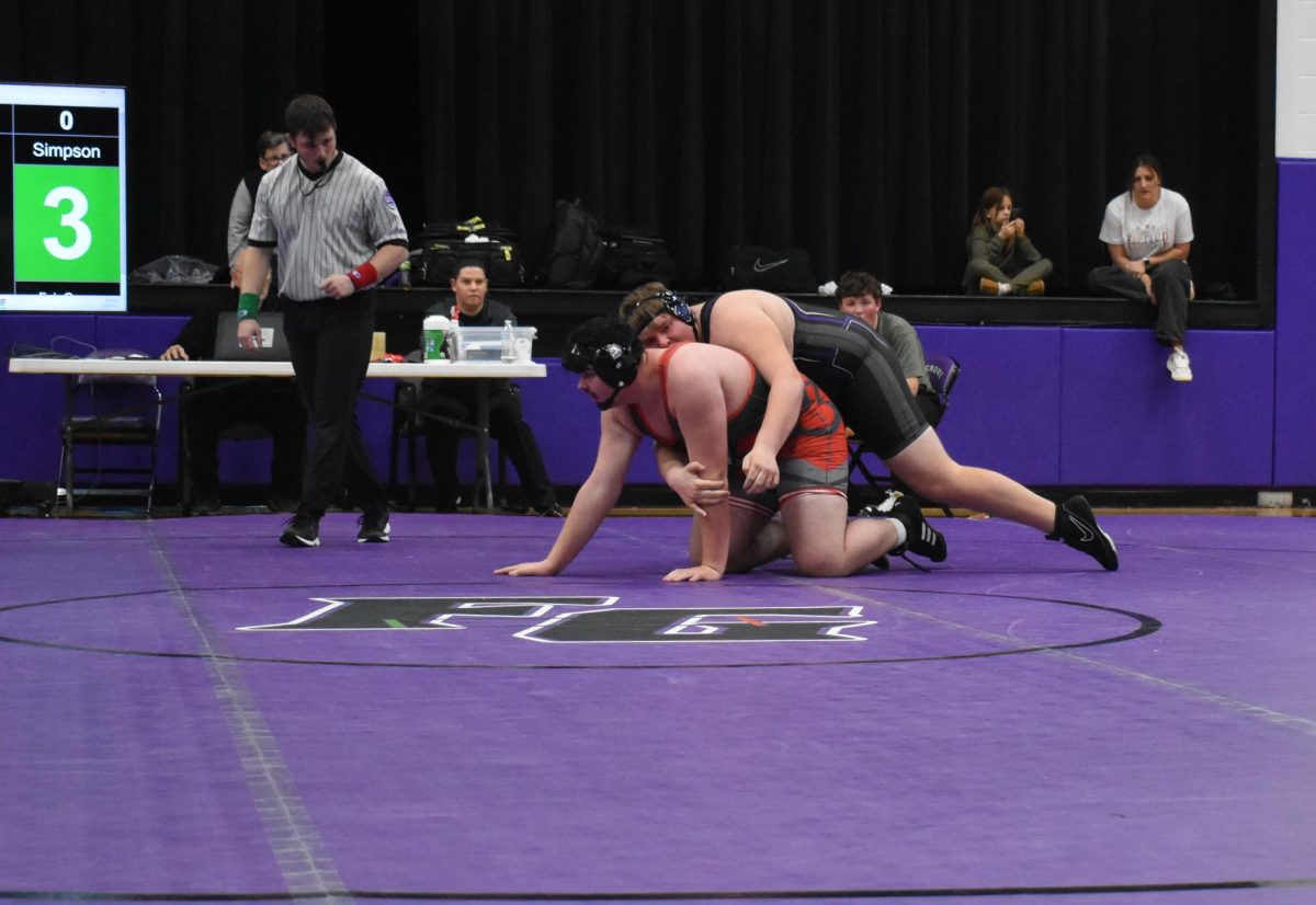 Samuel Simpson (11) at the 2025 home meet grappling an opponent from El Dorado Springs. Simpson proceeded to win his match.