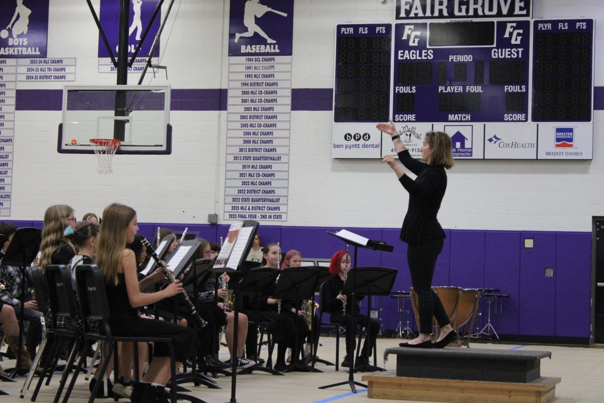 Band Director Natalie Palomo conducting for the 6th grade band during their fall concert. She is conducting them to crescendo.