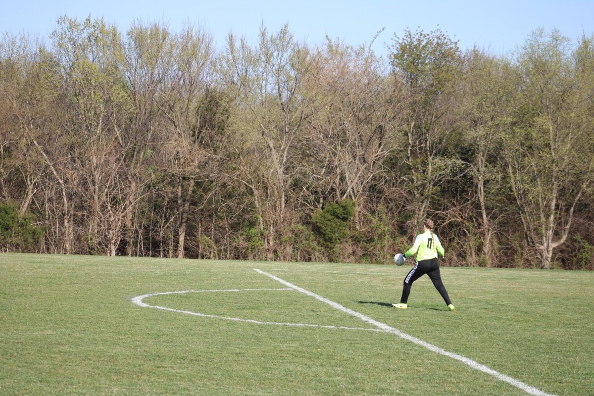Quincy Williams (12) drop kicks a soccer ball during a girls soccer game on March 31, 2025. Williams is a senior this year and will continue to play in the Goalkeeper position.