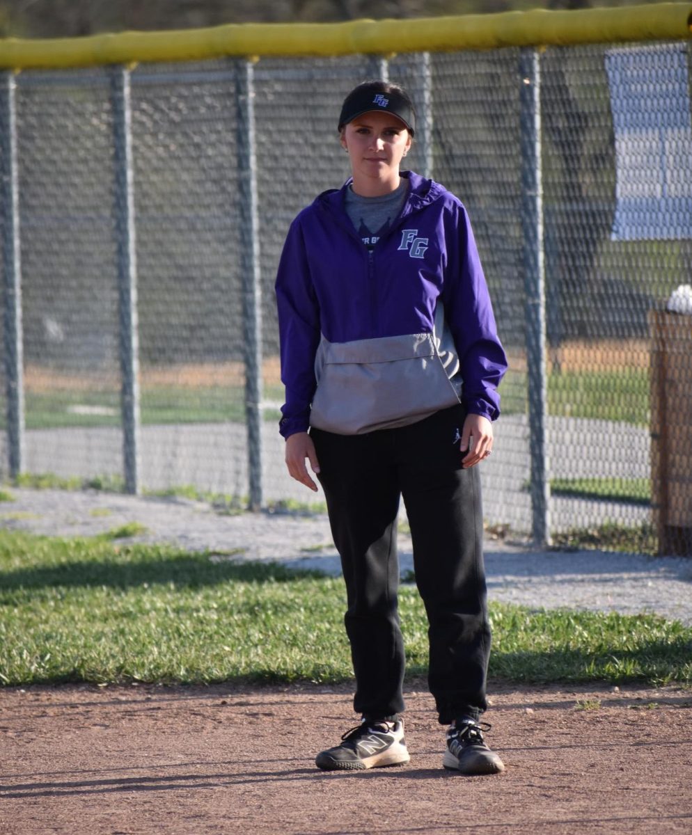 Shyan Lankford coaching runners from the first base line. Fair Grove Softball played Forsyth on April 7th, 2026 and won this game 9-0. 