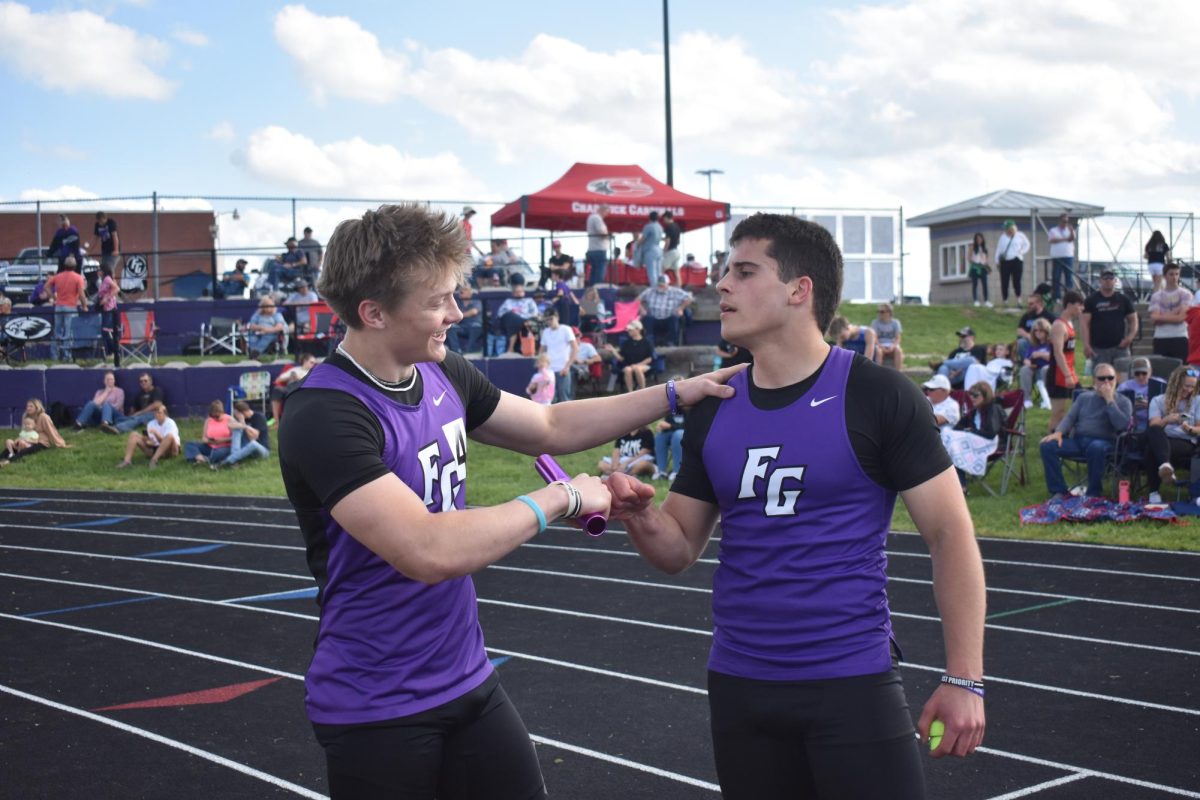 Track players Carson Trussell (12) and Dylan George (12) fist bumping at the 2024-2025 Fair Grove High School Track Home meet. The next high school track meet will be on April 27 at Buffalo followed by the home track meet on the 28. 