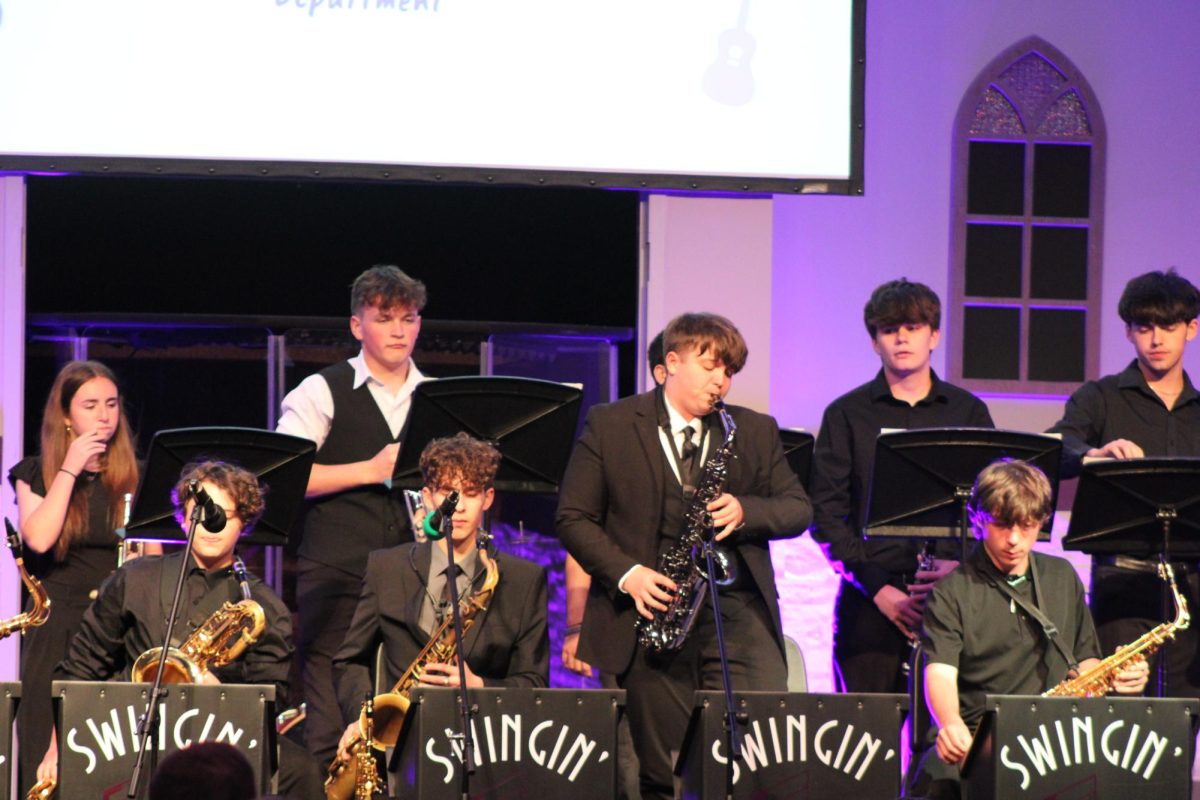 Anderson Teaster (10) peforming a solo during Evening of Jazz. Top row from left to right: Harlynn Irvine (10), Andrew McGuire (10), Jaiden Straw (12), Eli Sanders (12) Bottom row from left to right: Dexter Bennett (8), Wyatt Barber (11), Anderson Teaster (10), Patrick Griffin-Morris (9)
