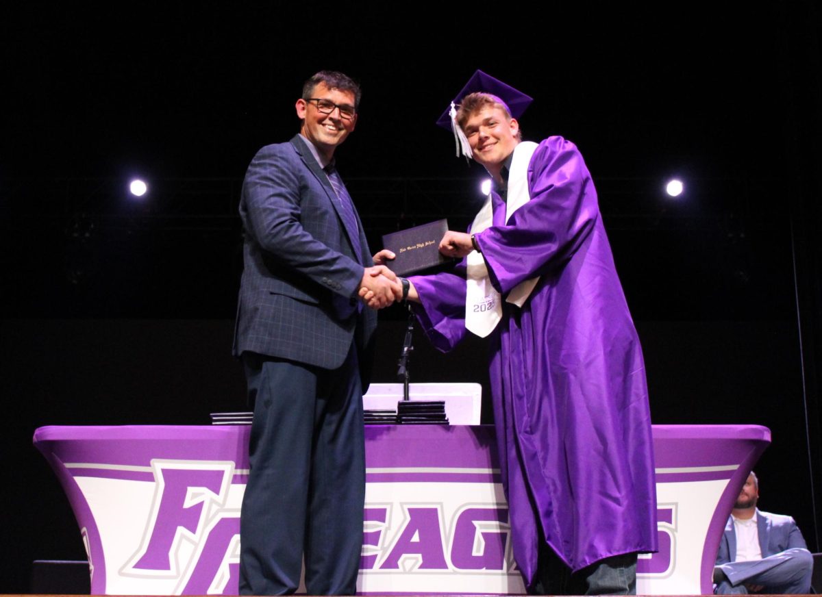 David Bruner at the 2025 Fair Grove Graduation, as he hands a diploma to his son, 2025 graduate Brock Bruner.