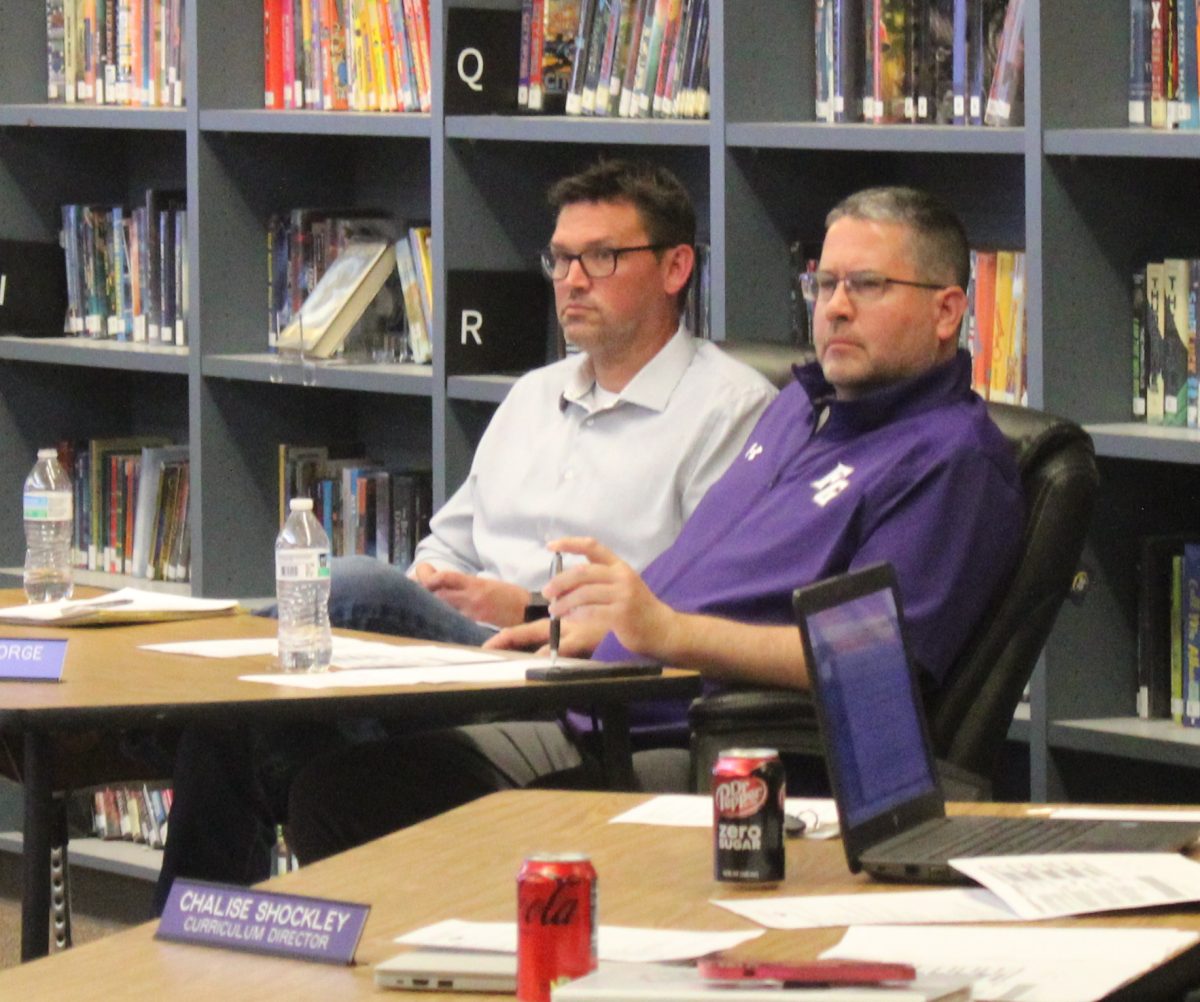 David Bruner sitting next to Jeremy George at the school board meeting on 3/25/2025.