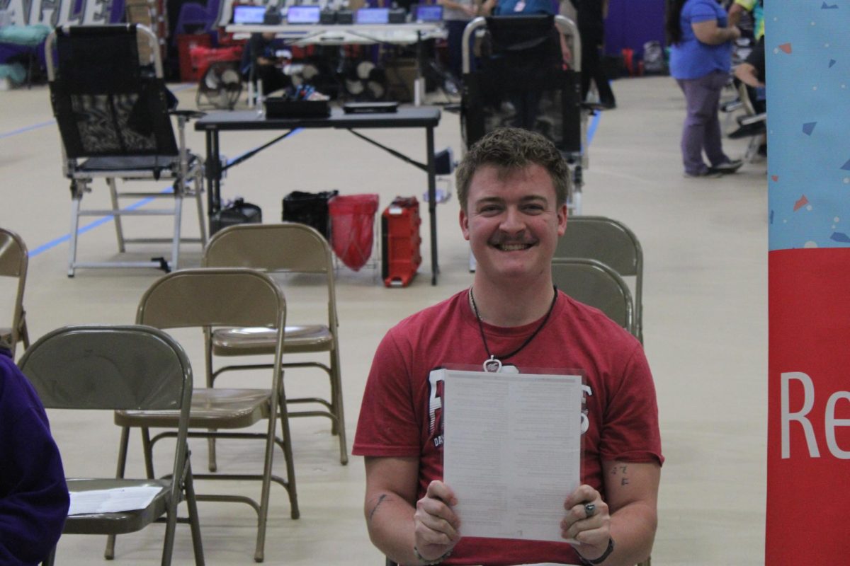 Waylon Wright (12) ready to donate blood to save up to three lives. Write is filling out his form to prepare to give blood.