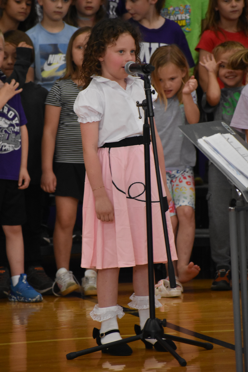 First grader Penelope Johnsen singing a solo at the First Grade Music and Art Show. This event happened on April 16th, 2025 at the elementary school gym. 

